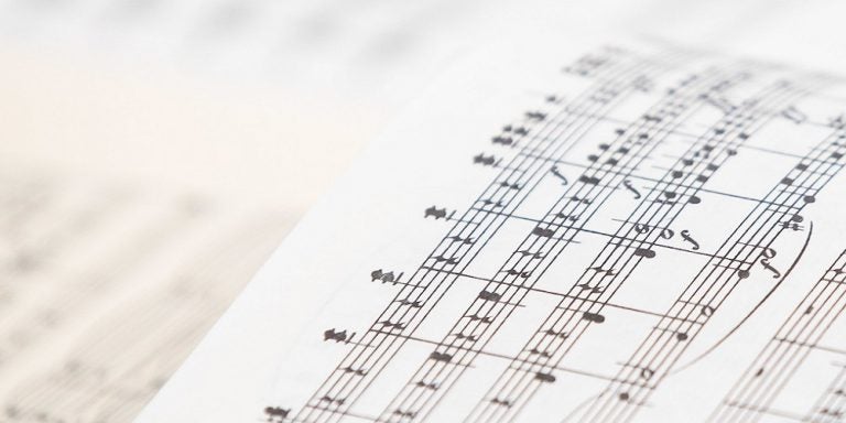 two musical scores open to the middle of composers work.  