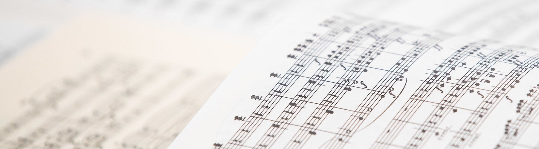two musical scores open to the middle of composers work.  