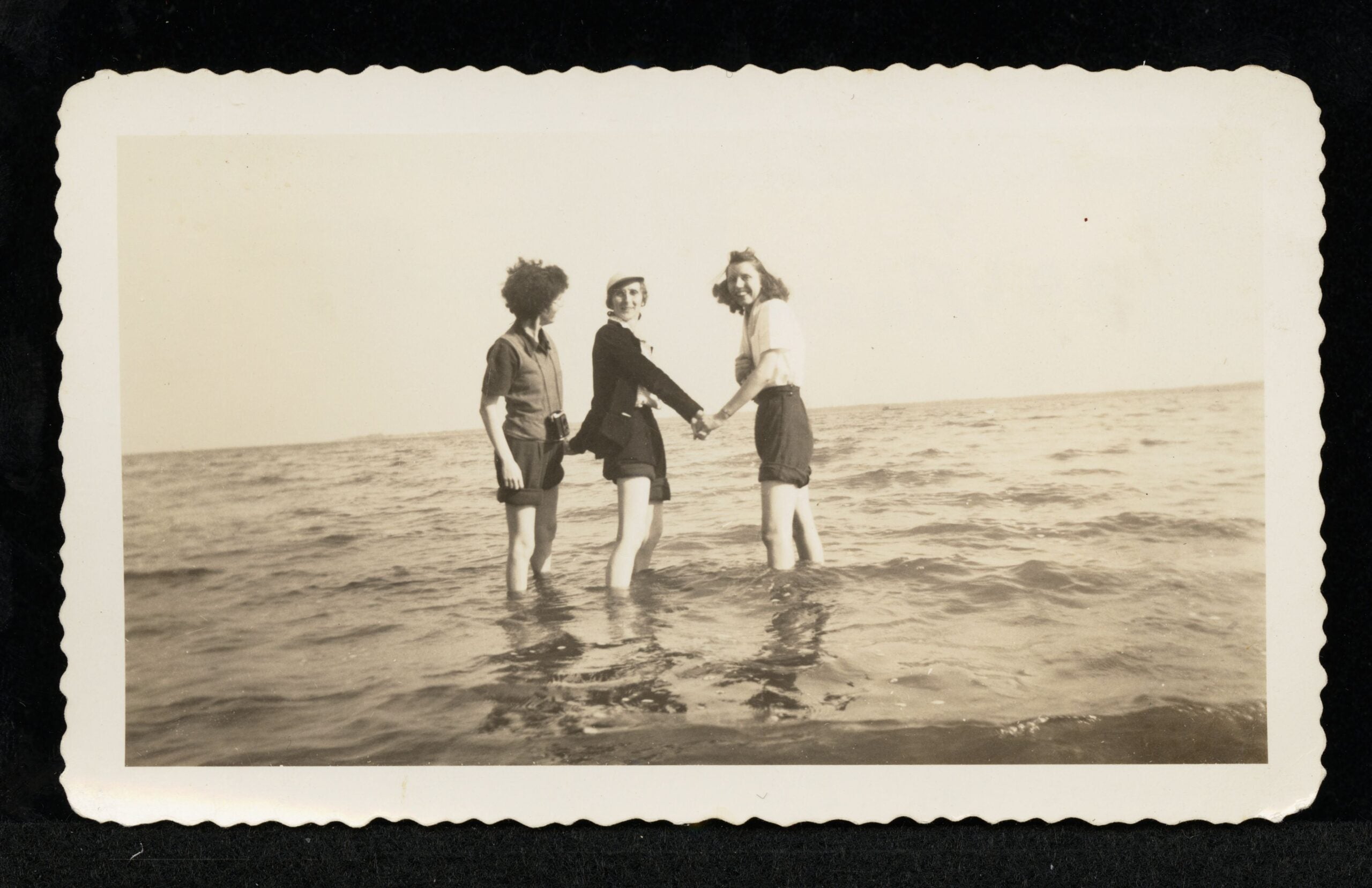 Three women standing in water
