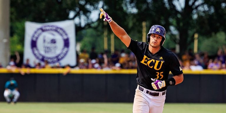 Bryson Worrell rounds the bases for a home run and signals to the crowd during the 2022 NCAA Greenville Regional. (ECU Photo by Cliff Hollis)