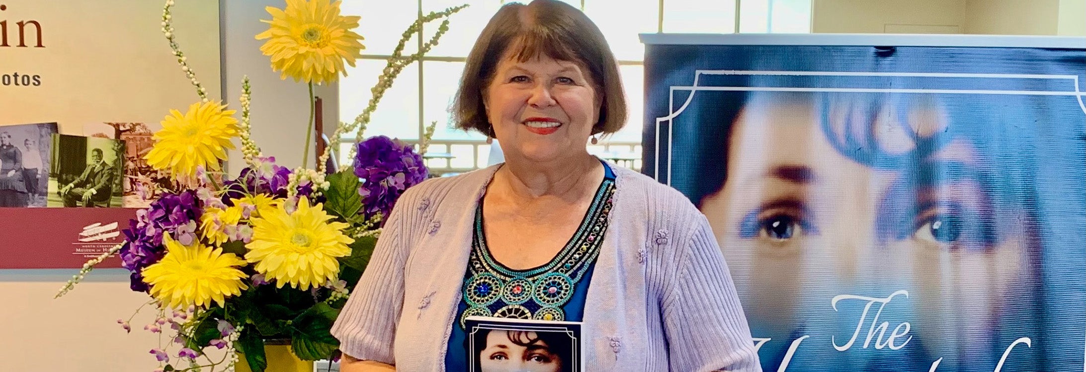 Donna Flake is pictured at the Janice Hardison Faulkner Gallery entrance for a reading of “The Haunted Life of Lura.” (Photo by Ronnie Woodward)