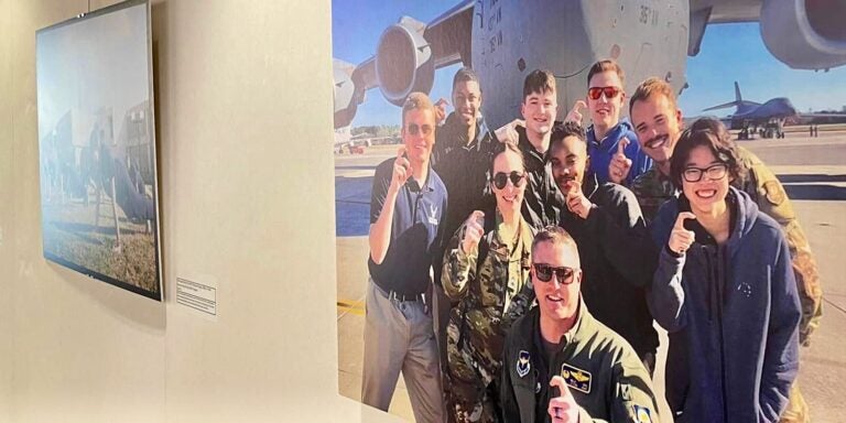 A wall on the first floor of the main campus library near Research & Instructional Services displays canvas photos in the exhibition “75 Years of Detachment 600: East Carolina’s Air Force ROTC.” 