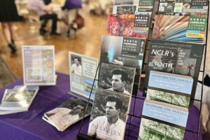 Books displayed on a purple table.