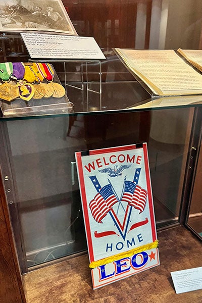A display case with World War II items inside of it.
