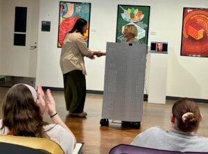 Two women standing at a podium shaking hands