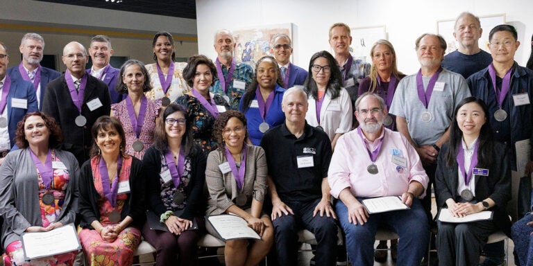 Authors and editors in a group smiling after their awards ceremony.