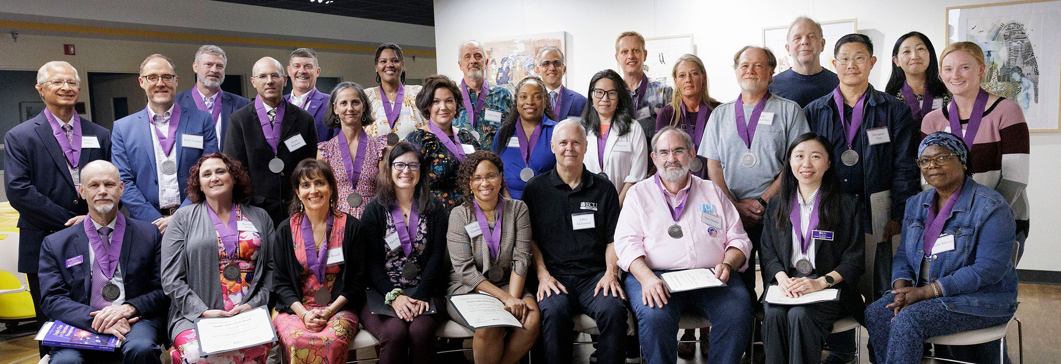 Authors and editors in a group smiling after their awards ceremony.